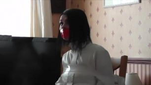 Girl in Straitjacket Gagged and Tape Chairtied